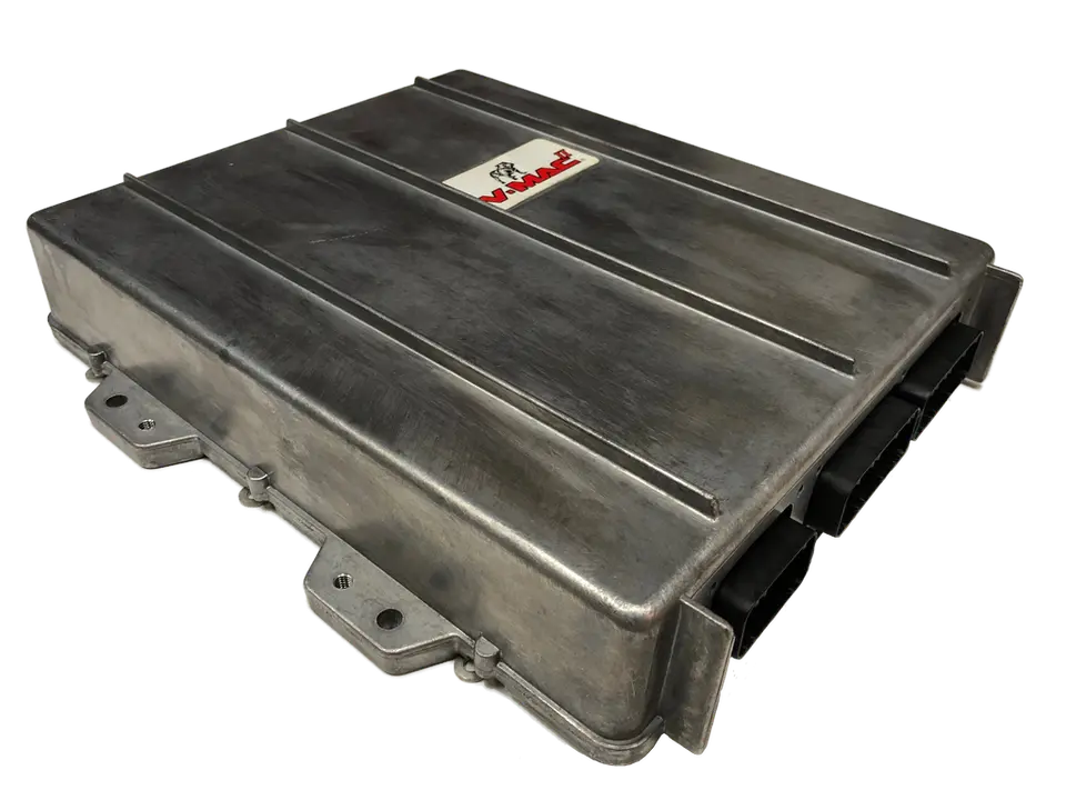 ECM Mack V-MAC — caja de aluminio con aletas y conectores rectangulares; se monta cerca de la cabina, no en el motor